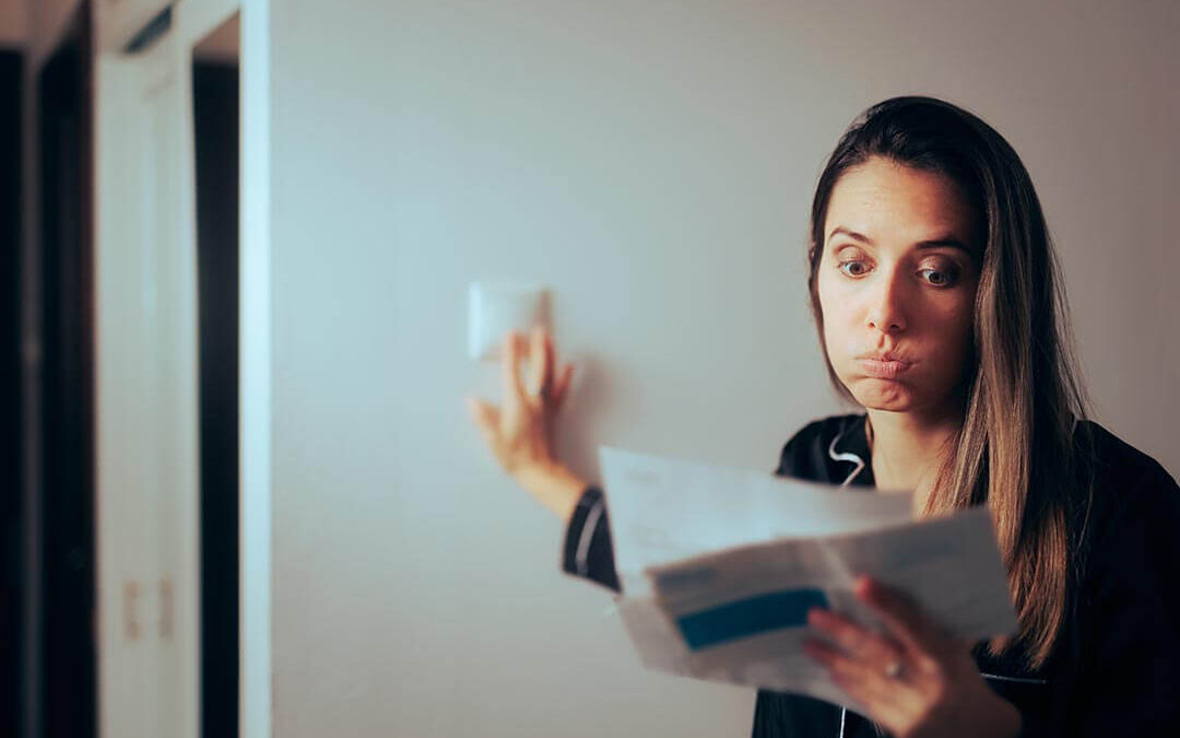 Woman Checking Electricity Bill Turning out the Lights at Home