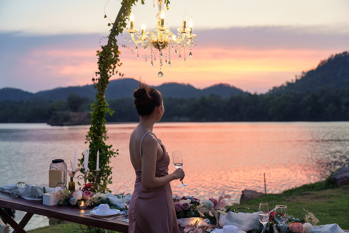woman standing holding a wine glass